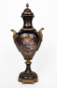 A reproduction blue and gilt metal porcelain urn in the Sevres style, 20th century, 66cm high.