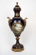 A reproduction blue and gilt metal porcelain urn in the Sevres style, 20th century, 66cm high. - 2