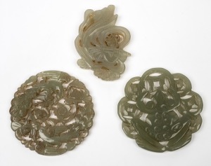 Three vintage Chinese carved jade amulets, 20th century, the largest 5.5cm wide.