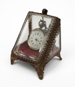 An antique sterling silver ladies cased pocket watch, housed in an original triangular antique glass and gilt metal silk lined box, 19th century, 8cm high overall.