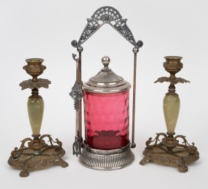 A pair of green onyx and brass candlesticks; together with a ruby glass pickle jar with silver plated mounts, 19th/20th century, (3 items), the largest 29cm high.