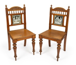 A pair of antique carved English oak Arts & Crafts hall chairs with tiled backs, 19th century, 95cm high.