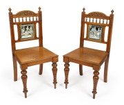 A pair of antique carved English oak Arts & Crafts hall chairs with tiled backs, 19th century, 95cm high.
