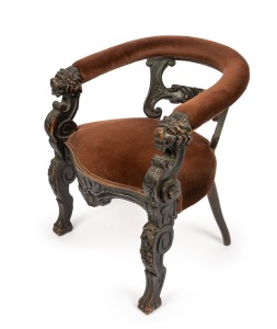 An antique Continental carved oak tub chair with lion mask hand grips and fruit decoration, 19th century, 75cm high, 65cm across the arms.