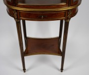 An attractive antique French mahogany display cabinet of oval form, with shelf base and adorned with ormolu mounts, circa 1880, 153cm high, 71cm wide, 42cm deep. - 2
