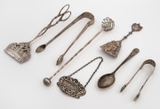 Silver swizzle stick, sterling silver sugar tongs, sterling silver sugar nips, Dutch silver biscuit tongs and sugar scoop, a sterling silver teaspoon and a sterling silver sherry decanter label, 19th/20th century, (7 items), the largest 19cm long, 176 gra