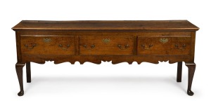 A Georgian oak three drawer Welsh dresser base with cabriole legs, original brass escutcheons and swan neck handles, circa 1760s, 79cm high, 203cm wide, 47cm deep. PROVENANCE: Purchased by the vendor from John Dunn Antiques in 1999 for $23,000. Purchase documentation included.