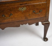 A Georgian oak three drawer Welsh dresser base with cabriole legs, original brass escutcheons and swan neck handles, circa 1760s, 79cm high, 203cm wide, 47cm deep. PROVENANCE: Purchased by the vendor from John Dunn Antiques in 1999 for $23,000. Purchase - 3