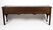 A Georgian oak three drawer Welsh dresser base with cabriole legs, original brass escutcheons and swan neck handles, circa 1760s, 79cm high, 203cm wide, 47cm deep. PROVENANCE: Purchased by the vendor from John Dunn Antiques in 1999 for $23,000. Purchase - 4