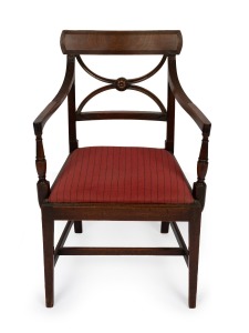 An antique English mahogany Hepplewhite spade back armchair with reeded decoration and floral rondel, late 18th century, 83cm high, 54cm across the arms.
