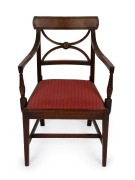An antique English mahogany Hepplewhite spade back armchair with reeded decoration and floral rondel, late 18th century, 83cm high, 54cm across the arms.