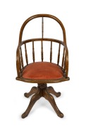 An antique American oak swivel base captain's chair, 19th century, 52cm across the arms.