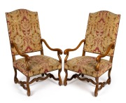 A pair of reproduction French carved beech armchairs with acanthus pattern upholstery, 20th century in the 18th century style, 120cm high, 60cm across the arms.