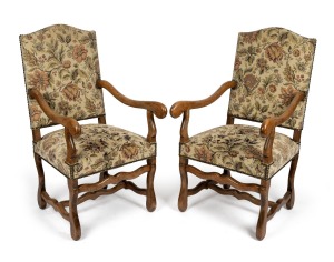 A pair of reproduction French style armchairs with carved beech frames and floral tapestry upholstery, 20th century in the 18th century style, 110cm high, 59cm across the arms.