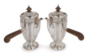 A pair of antique English sterling silver chocolate pots with carved timber handles and finials, by Addie Bros. of Birmingham, 20th century, ​​​​​​​20cm high, 812 grams total including handles and finials.
