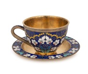 A Russian silver teacup and saucer with enamel floral decoration and original gilt finish, stamped "916" with Soviet assay mark and Cyrillic maker's mark, the saucer 11cm diameter, 233 grams total.