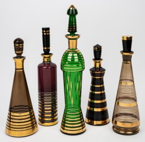 Five vintage Bohemian coloured glass decanters with gilt decoration, mid 20th century, the largest 44cm high.