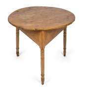 A Georgian provincial pine, elm and beech circular cricket table with three legs and triangular form base, 18th/19th century, 71cm high, 77cm wide.