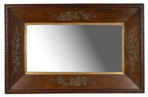 An antique oak framed mirror with applied flannel flower decoration, early 20th century, 85 x 55cm overall.