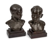 DUCAM pair of bronze busts of a girl and boy, mounted on timber plinths, both signed "Ducam", 23cm and 24cm high.