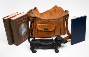 Leather bag, reproduction sausage dog boot scraper and three books on Joseph Banks and Nicolas Baudin, (5 items).