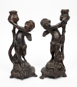 A pair of French bronze cherub candlesticks, 20th century, 29cm high.