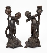 A pair of French bronze cherub candlesticks, 20th century, ​​​​​​​29cm high.