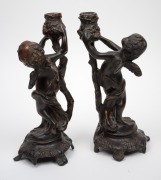 A pair of French bronze cherub candlesticks, 20th century, ​​​​​​​29cm high. - 2