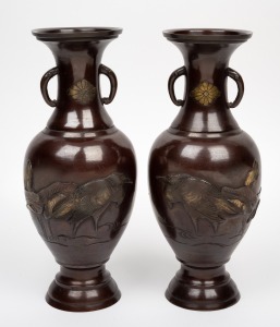 A pair of Japanese bronze vases with heron and water lily decoration, Meiji Period, 19th/20th century, 30cm high.