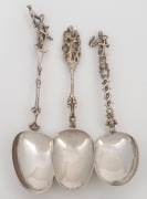 Three assorted antique Continental silver serving spoons all with figural finials, 18th/19th century, ​​​​​​​the largest 19cm high, 146 grams total.
