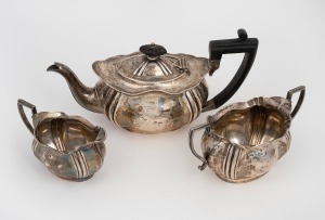 A three piece antique English sterling silver tea service, made in Sheffield, circa 1910, the teapot 13cm high, 25cm wide, 668 grams total including handle.