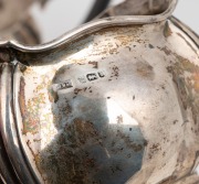 A three piece antique English sterling silver tea service, made in Sheffield, circa 1910, the teapot 13cm high, 25cm wide, 668 grams total including handle. - 3