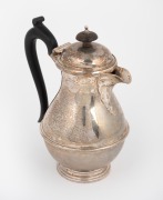A sterling silver jug with carved timber handle and finial, made in Sheffield, early 20th century, 17cm high, 422 grams total including handle and finial.