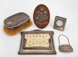 Sterling silver calendar, vintage brush, silver cased clock, decanter label and tennis trophy, 20th century, (5 items), the largest 15.5cm wide.