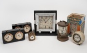 A marble and black slate Art Deco table clock, two chess clocks, a circular marble German table clock and a German miniature bedside alarm clock; together with an Ever Ready Chronos Flip Clock, 20th century, (6 items), ​​​​​​​the largest 18cm high.