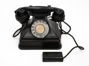 A vintage black bakelite pyramid telephone, mid 20th century, ​​​​​​​22cm wide.