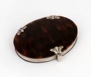 An antique silver mounted tortoise shell folding magnifying glass, 19th century, 8.5cm high when closed.