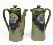 MOORCROFT rare and early "Pansy" pattern teapot and companion hot water pot on celadon green ground, (2 items), both impressed "MOORCROFT BURSLEM" with green signature "W. Moorcroft", ​​​​​​​15.5cm high.
