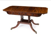 An antique Regency mahogany sofa table, the cantered corner mahogany top crossbanded with rosewood, ebony and boxwood stringing, two drawers to the frieze, turned support base with quadraform splay legs terminating on brass lion paw castors, circa 1825, 7 - 2
