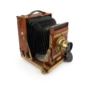 THORNTON-PICKARD: "Imperial" triple-extension view camera, late 19th century, plate dimensions 12 x 16.5cm, with rare Voigtl&auml;nder & Sohn Collinear II f5.4 No. 4 brass lens and "Baker & Rouse" retailer's inlay.
