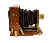 LANCASTER: "Instantograph" view camera, late 19th century, plate dimensions 11.5 x 16.5cm, fixed-aperture Lancaster brass lens, burgundy bellows, unusual rear hinge mechanism. - 2