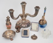 Continental silver three branch candelabra (weighted base); together with two miniature silver picture frames, three silver overlay bottles (one broken) and a silver and glass burner, (7 items).
