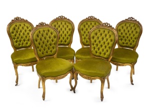A set of six antique English carved giltwood salon chairs with green velvet button back upholstery, circa 1860.