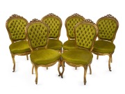 A set of six antique English carved giltwood salon chairs with green velvet button back upholstery, circa 1860.