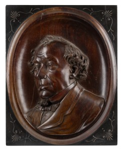 BENJAMIN DISRAELI, 1st Earl of Beaconsfield, carved wooden plaque, signed and titled "Disraeli, 1878, W. Hughes, Sculpt. Maidstone", 47 x 37cm.