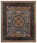 A framed Tibetan Mandala, hand-painted on cloth in woven silk surround, 20th century, 61 x 52cm overall.
