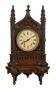 An antique English Gothic Revival oak cased bracket clock with bracket, eight day time and gong strike movement with Roman numerals, 19th century, 77cm high overall on bracket.
