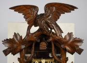 An antique German Black Forest cuckoo wall clock in carved linden adorned with vine leaf decoration and spread eagle finial, later fitted transparent dial plate displaying the fretted brass plate 30 hour movement, cuckoo and bellows. Fancy carved bone han - 2