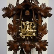 An antique German Black Forest cuckoo wall clock in carved linden adorned with vine leaf decoration and spread eagle finial, later fitted transparent dial plate displaying the fretted brass plate 30 hour movement, cuckoo and bellows. Fancy carved bone han - 3