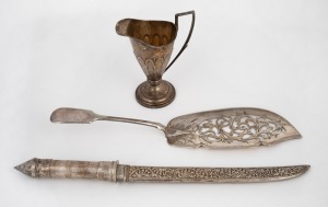 An antique sterling silver cream jug, a silver plate fish slice, and a vintage Chinese silver handle knife with scabbard, (3 items), the jug 11.5cm high, 90 grams.